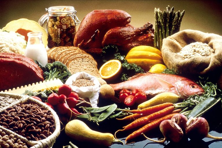 An assortment of fresh fruits, vegetables, whole grains, legumes, and nuts symbolizing the Microbiome Enhancer Diet, designed to boost gut health and energy metabolism