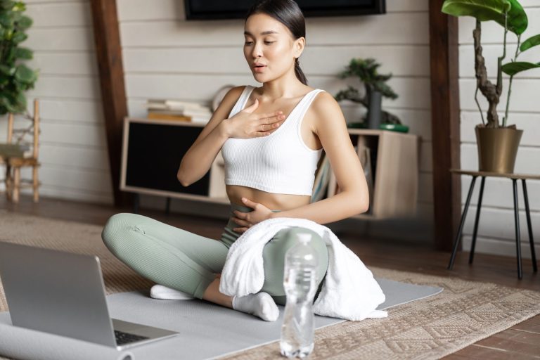 A woman practicing deep breathing exercises for stress management to improve health and promote longevity