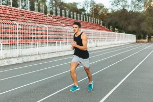 young-athletic-man-running-stadium-morning