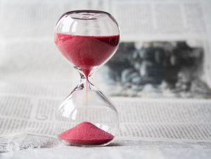 An hourglass representing the concept of two-minute longevity practices, with the flowing sand symbolizing the passage of time and the small yet impactful changes we can make in our daily routine for a healthier, longer life