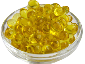 A cup overflowing with yellow softgel capsules, representing vitamin D supplements, illustrating the topic of the RDA vs. optimal dosage of vitamin D for heart health
