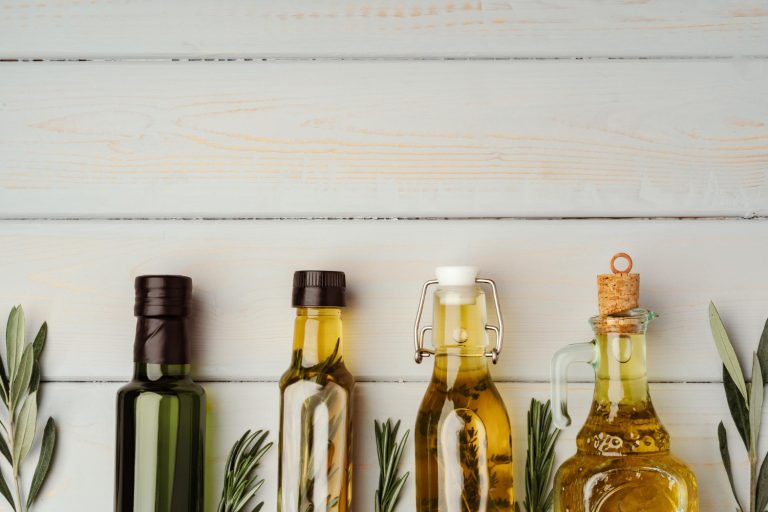 "Assorted bottles of cooking oils including seed oils and healthy alternatives, each displaying unique color and viscosity, symbolizing diverse nutritional profiles.